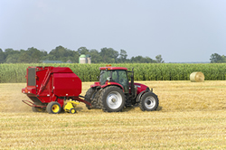 Tractor and Baler working hard in the field